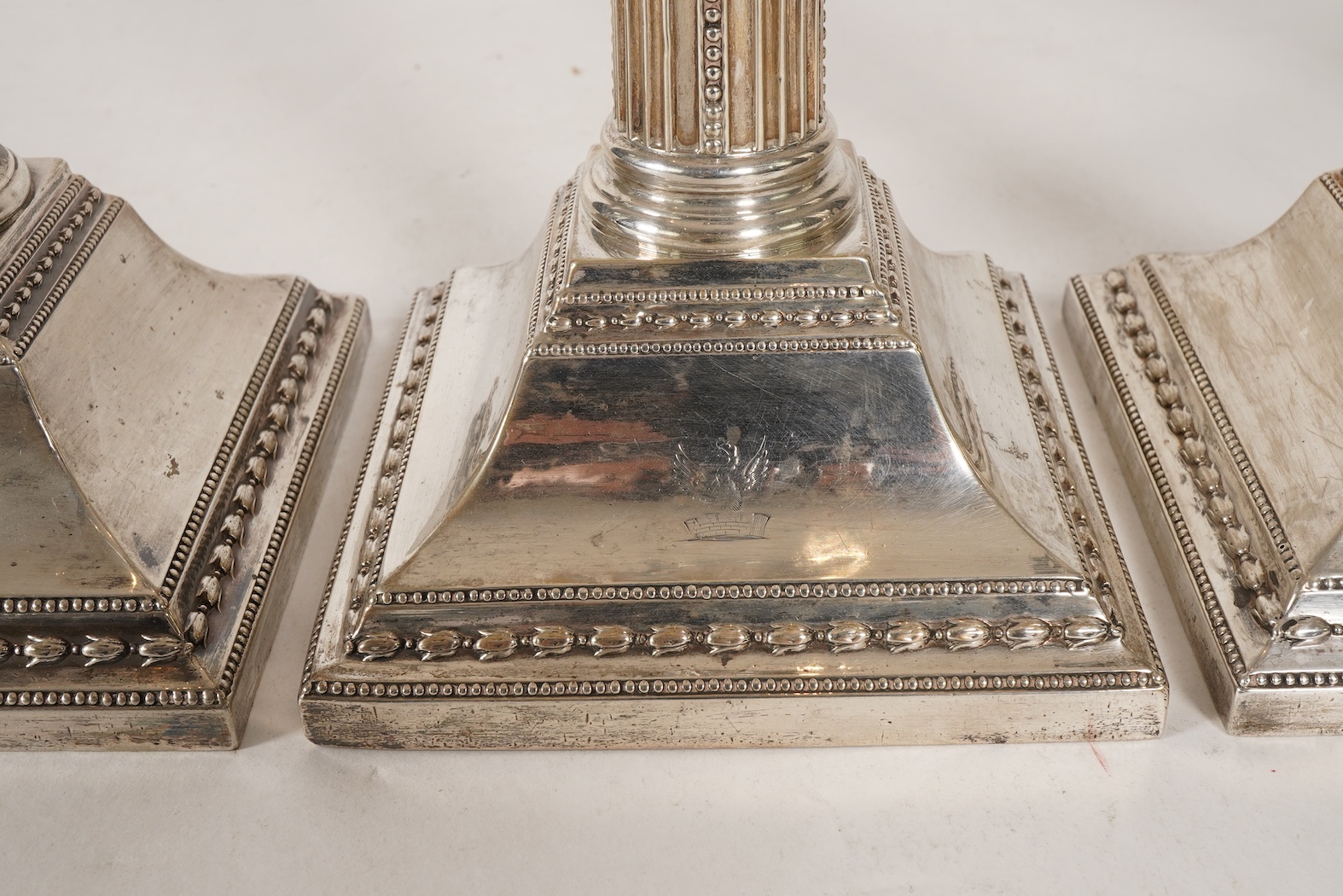 A set of four George III silver corinthian column candlesticks, by John Winter & Co